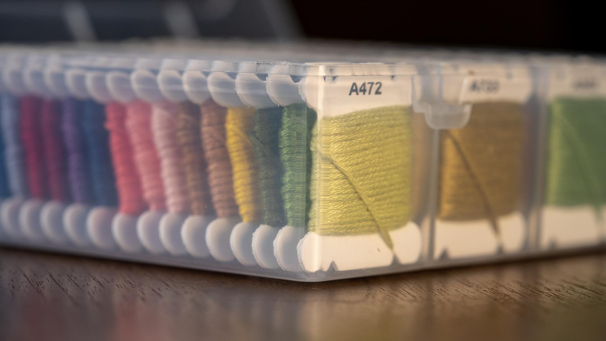 workbench with threads and stitched swatches